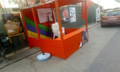an orange booth on a sidewalk
