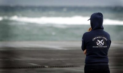 a man standing in front of water