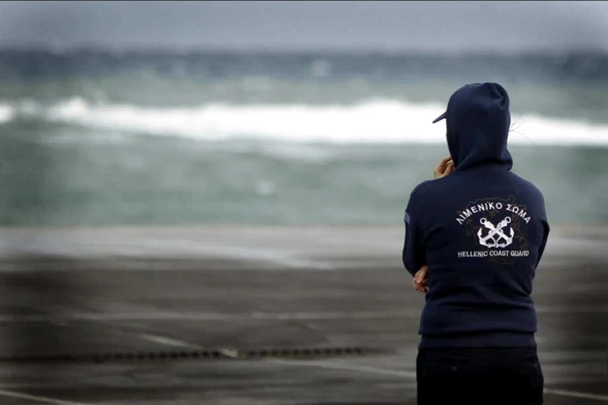 a man standing in front of water