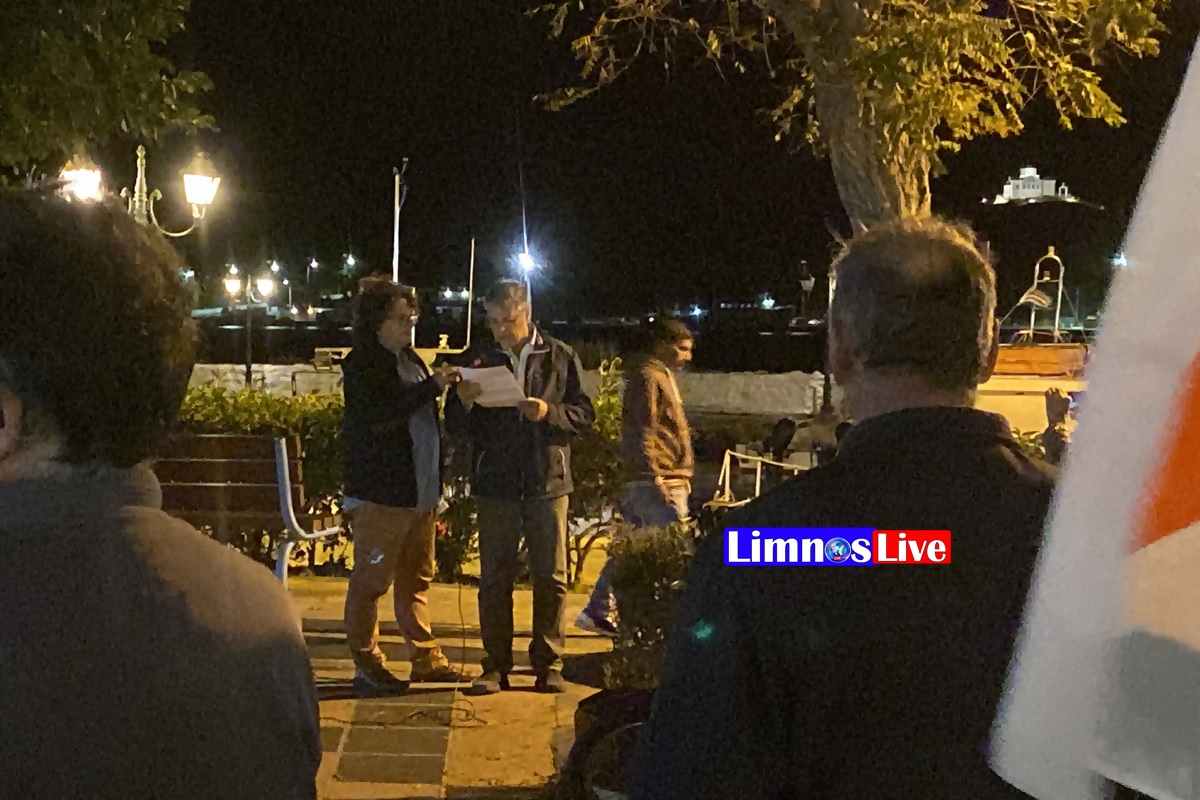 a group of people standing outside at night