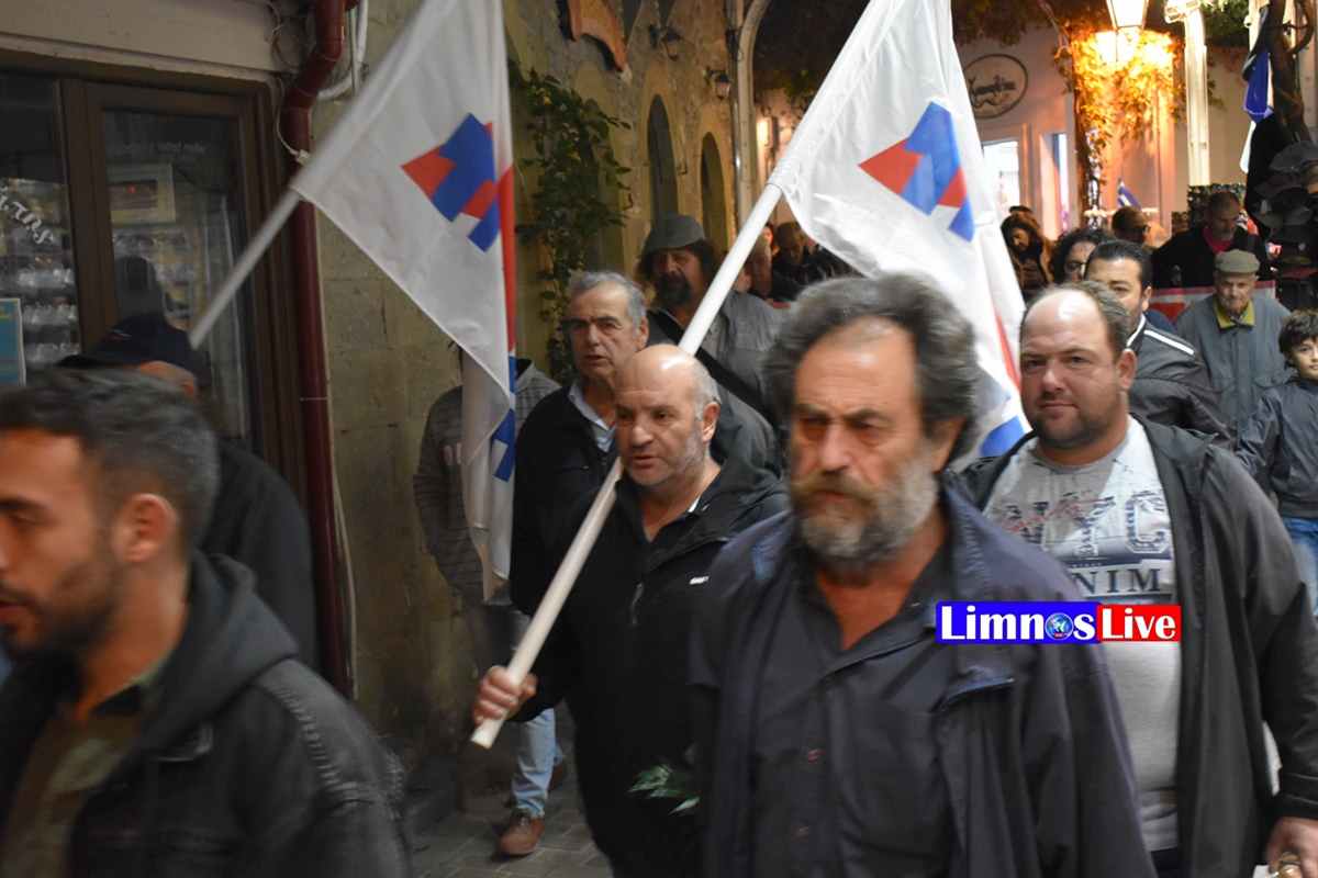 a group of people walking down a street holding flags