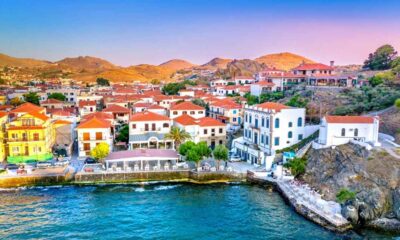 a town with red roofs and a body of water