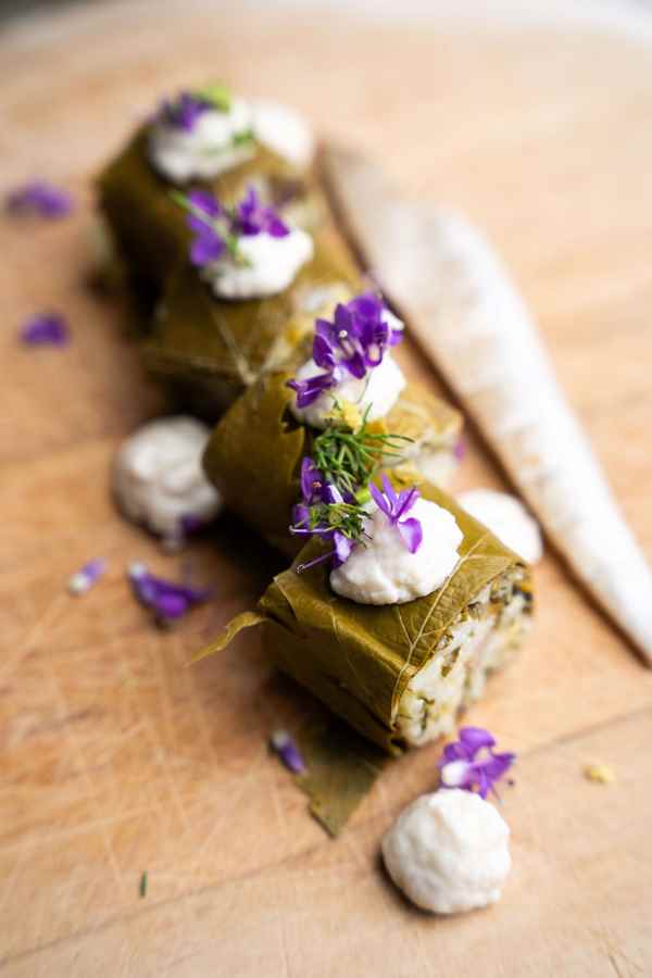 a bowl of food with a lemon and flowers