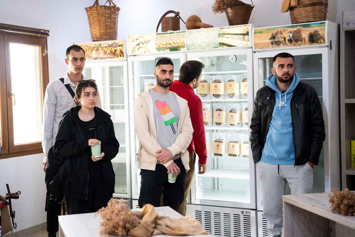 a group of people standing in front of a refrigerator