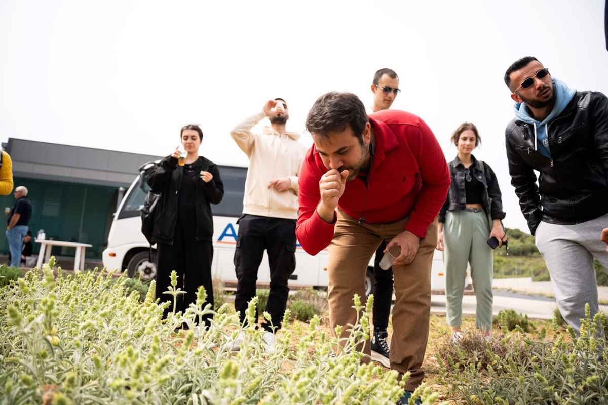 a group of people standing around a table with food