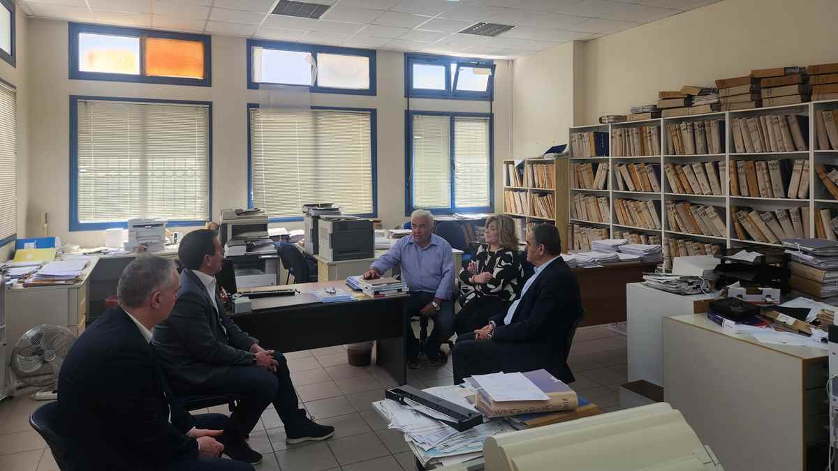 a group of people sitting around a desk in a room