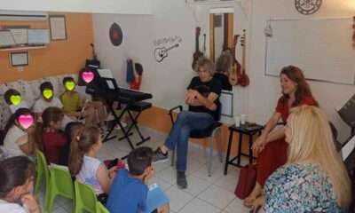 a basketball player in a green uniform with a ball in the air
