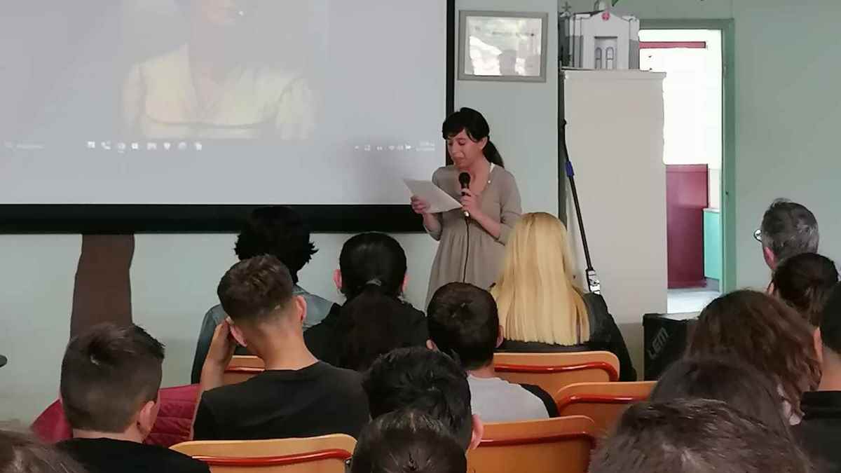 a woman standing in front of a screen