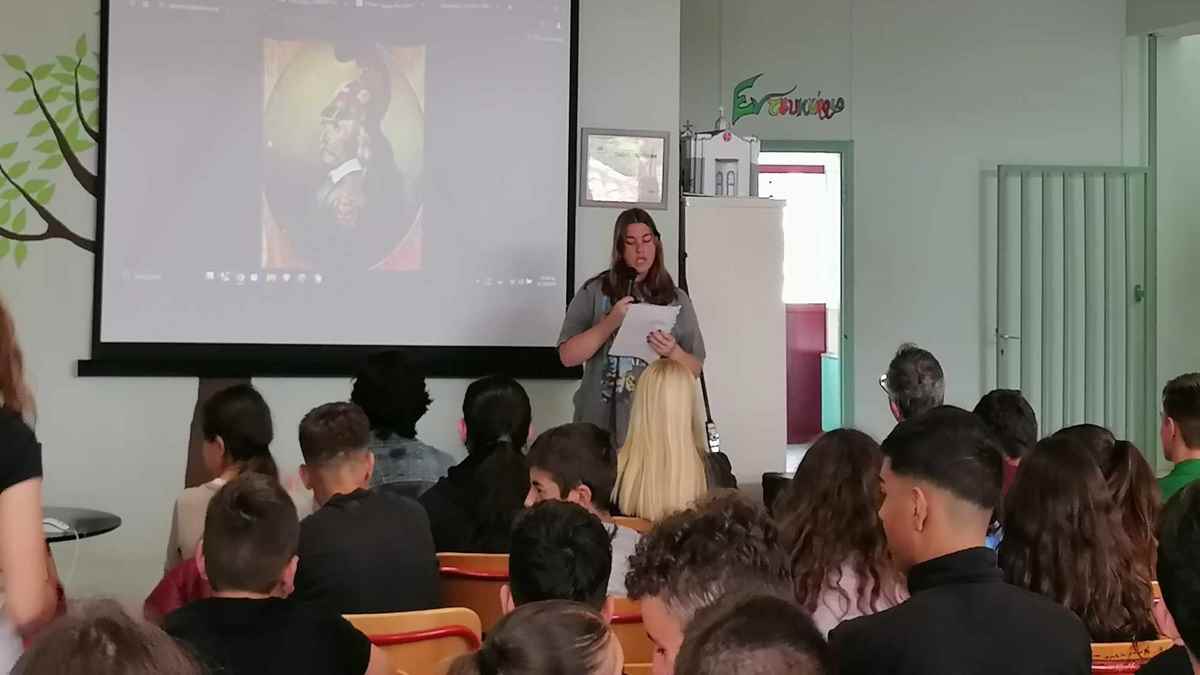 a woman standing in front of a large group of people