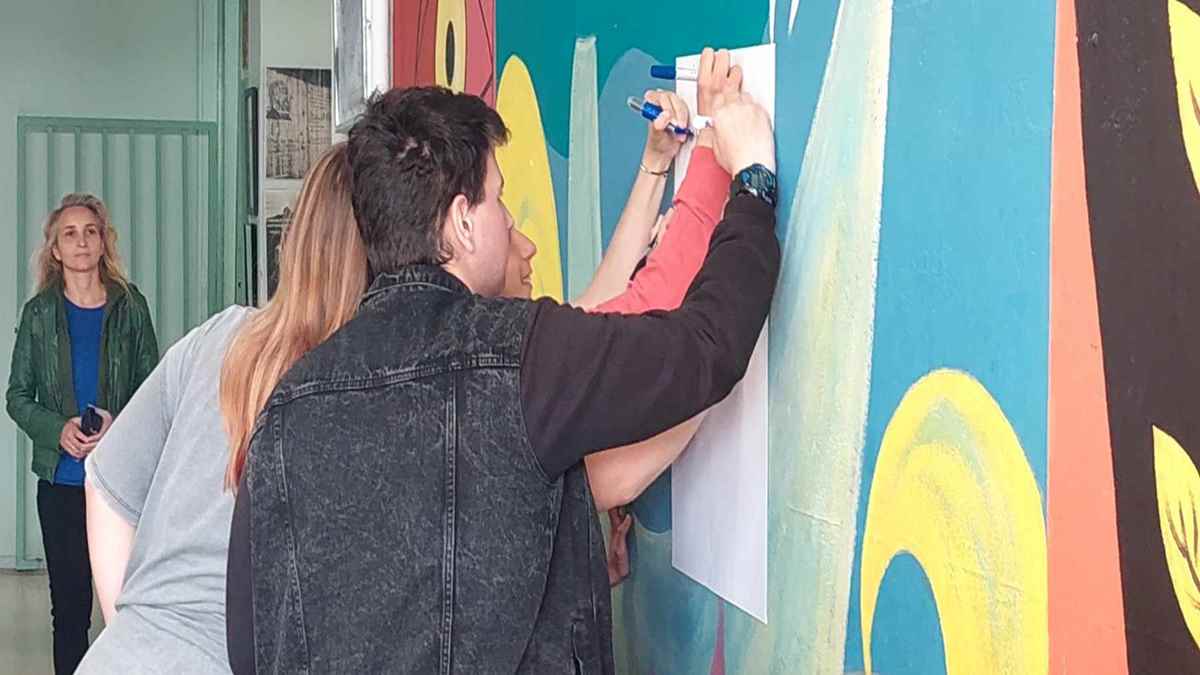 a man and woman writing on a wall