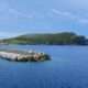 a rocky island with a hill in the background