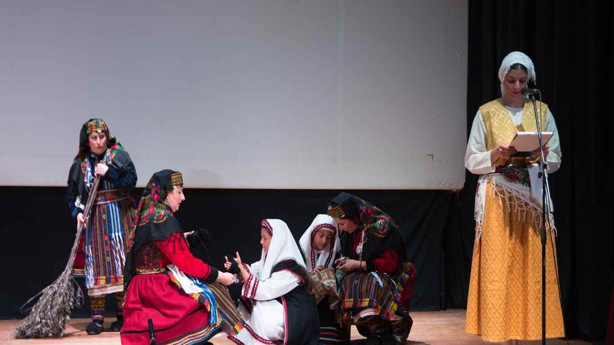 a group of people in traditional clothing on a stage