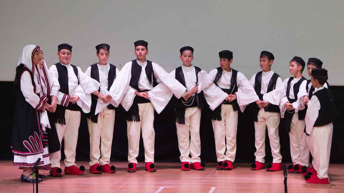 a group of boys wearing white and black clothes
