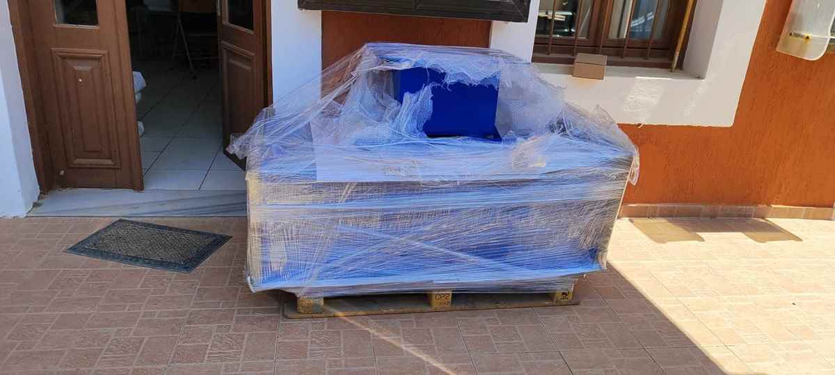 a box wrapped in plastic outside a building