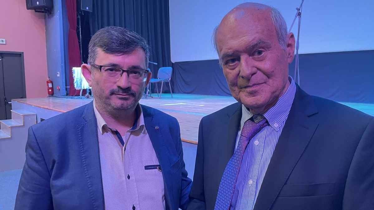 two men standing next to each other