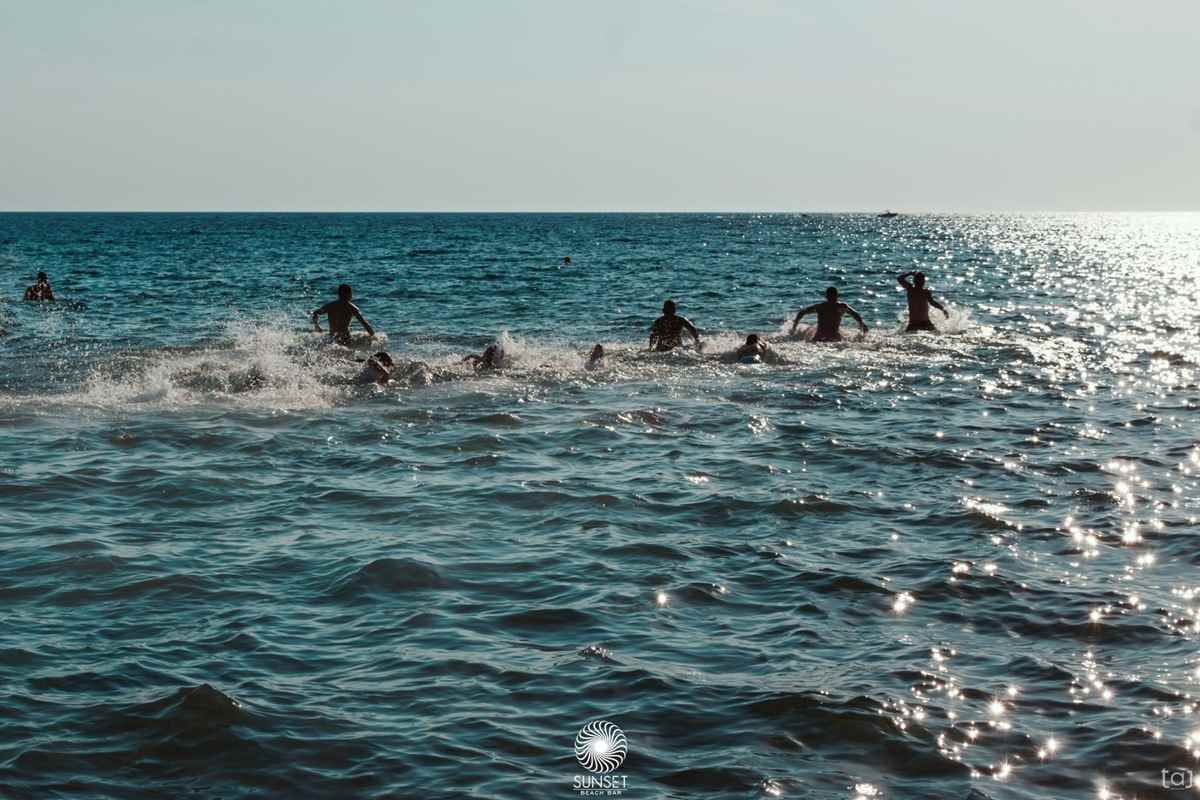 a group of people swimming in the ocean