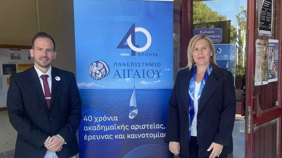 a man and woman standing in front of a sign