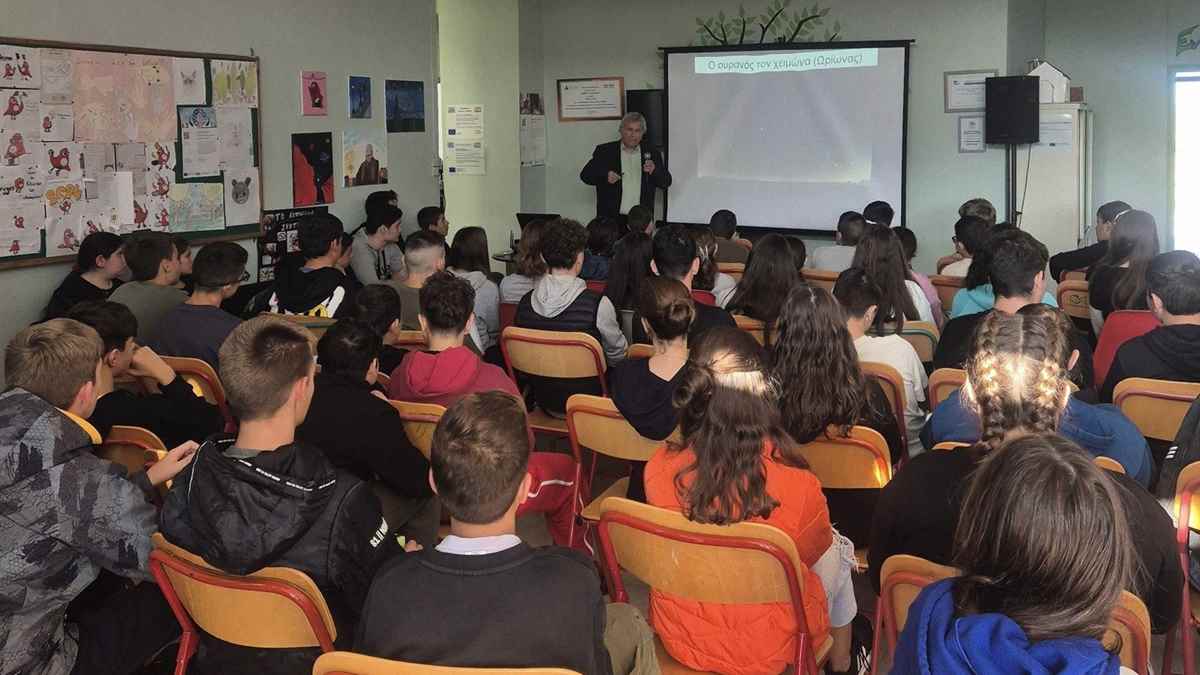 a man standing in front of a group of people in a classroom