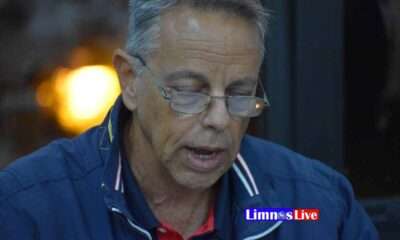 a man wearing glasses and a blue jacket