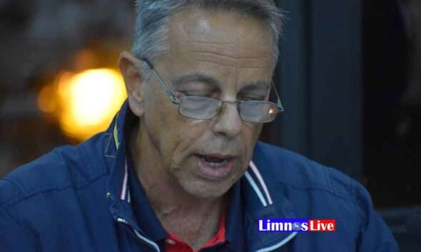 a man wearing glasses and a blue jacket