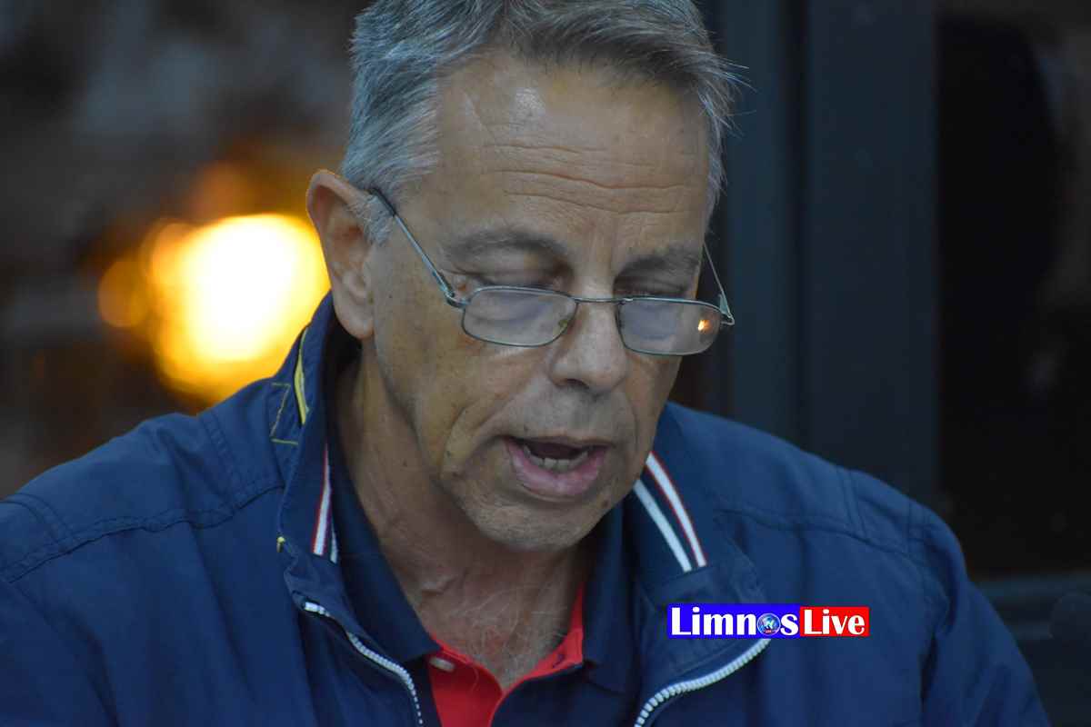 a man wearing glasses and a blue jacket