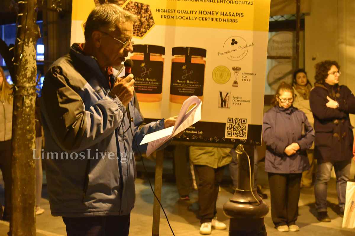 a man standing in front of a sign