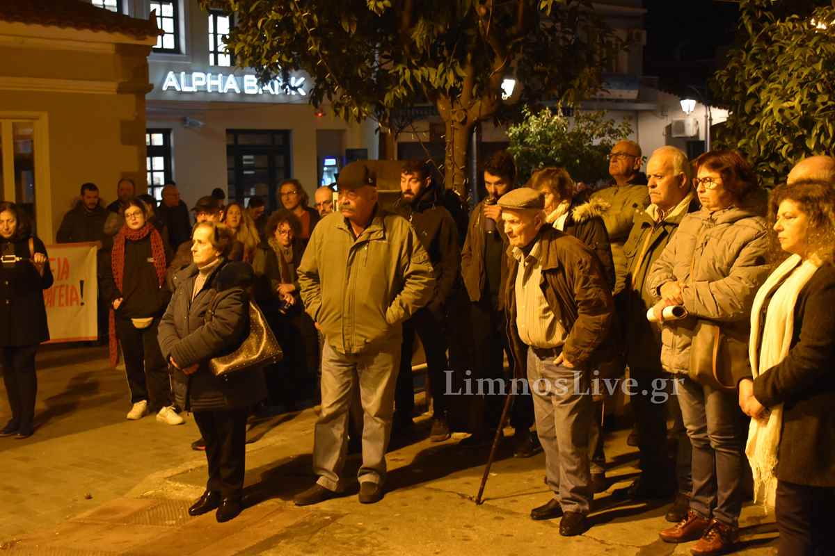 a group of people standing on a sidewalk