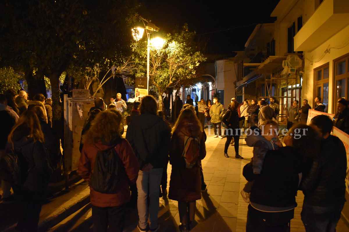 a group of people on a sidewalk