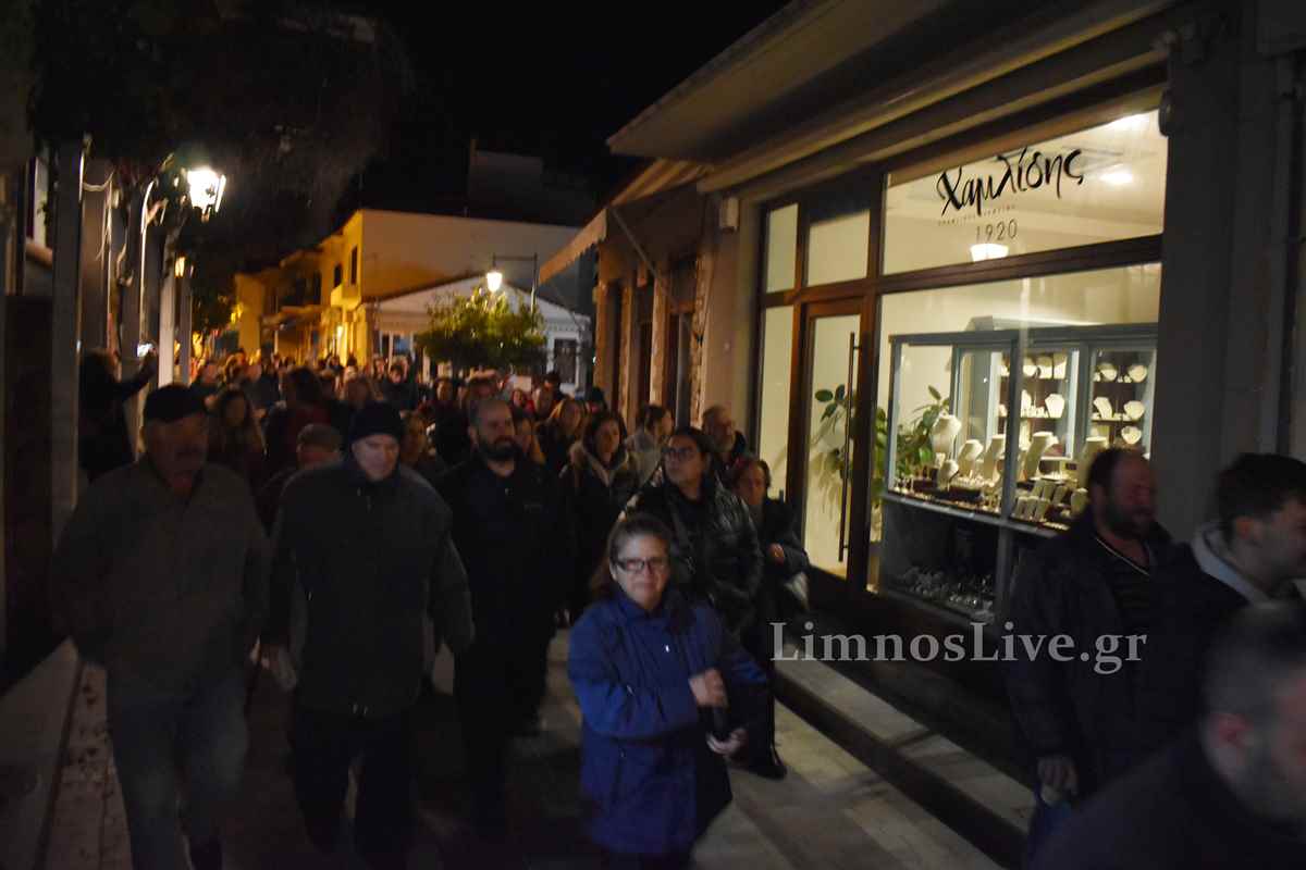 a crowd of people walking down a sidewalk