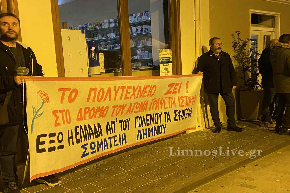 a man standing next to a banner