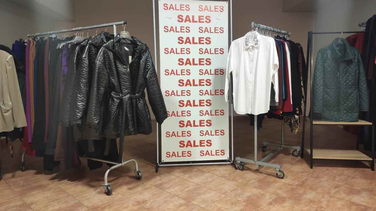 a sign with a sign and a coat on swingers