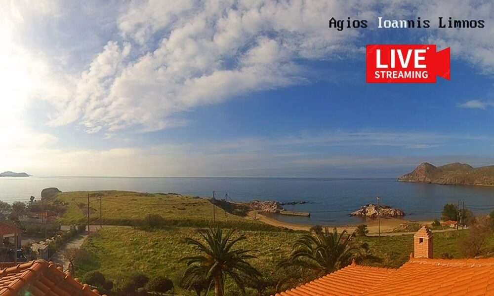 a view of a beach and grass and a building