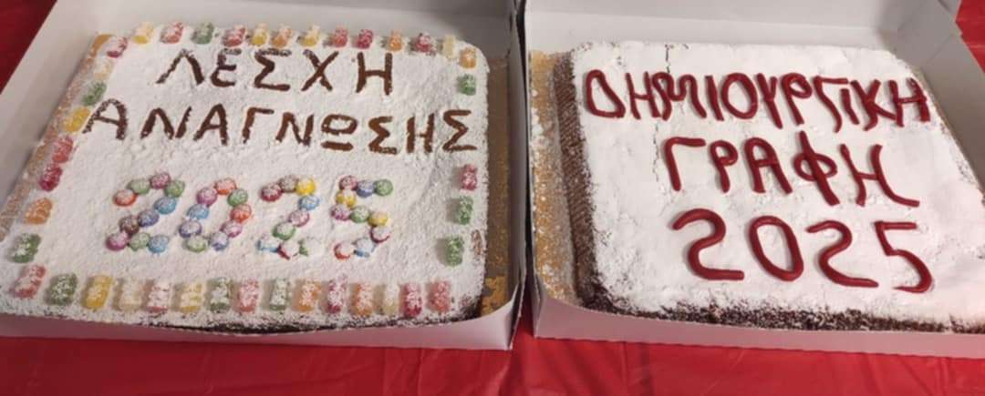 two cakes in boxes on a table