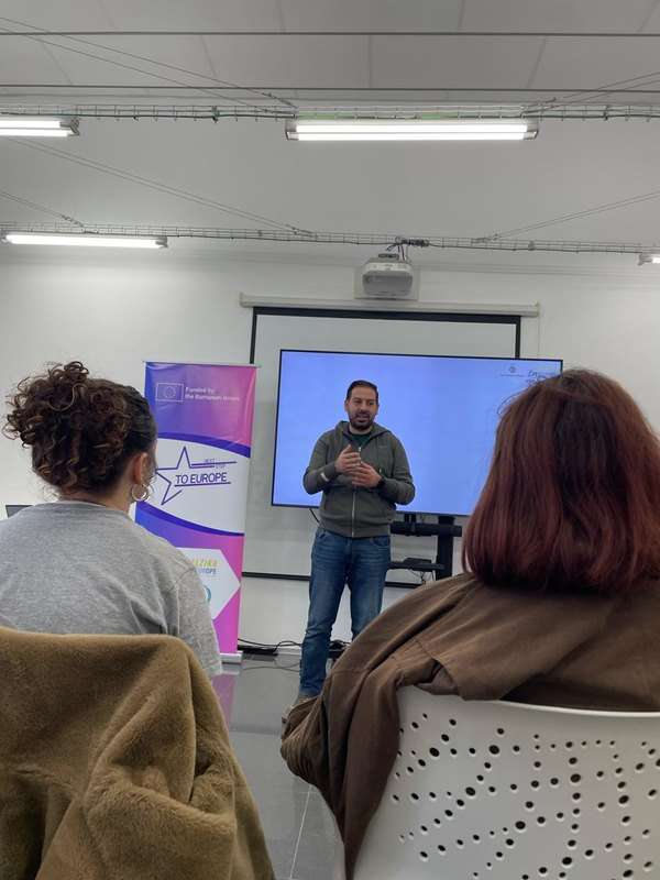 a man standing in front of a screen