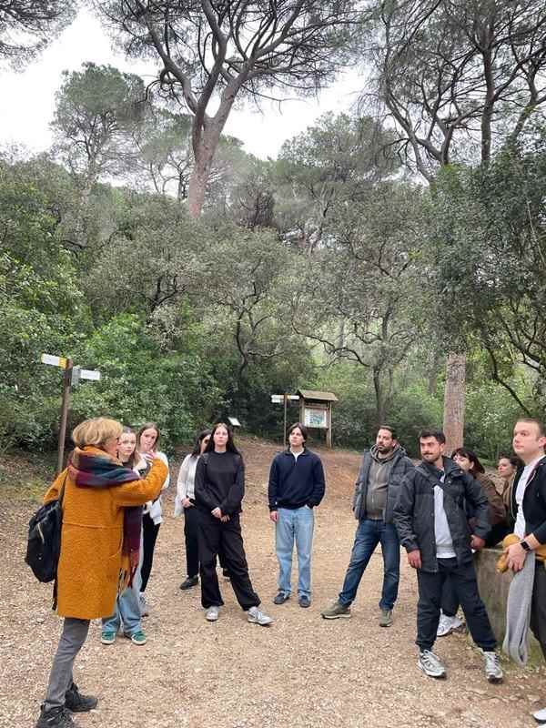 a group of people standing on a dirt path