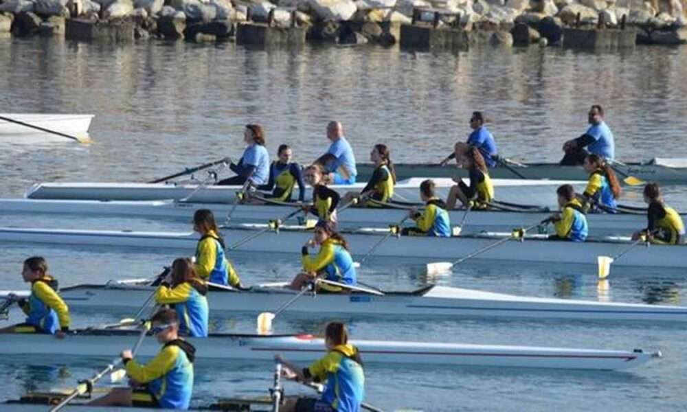 a group of people in a row of canoes