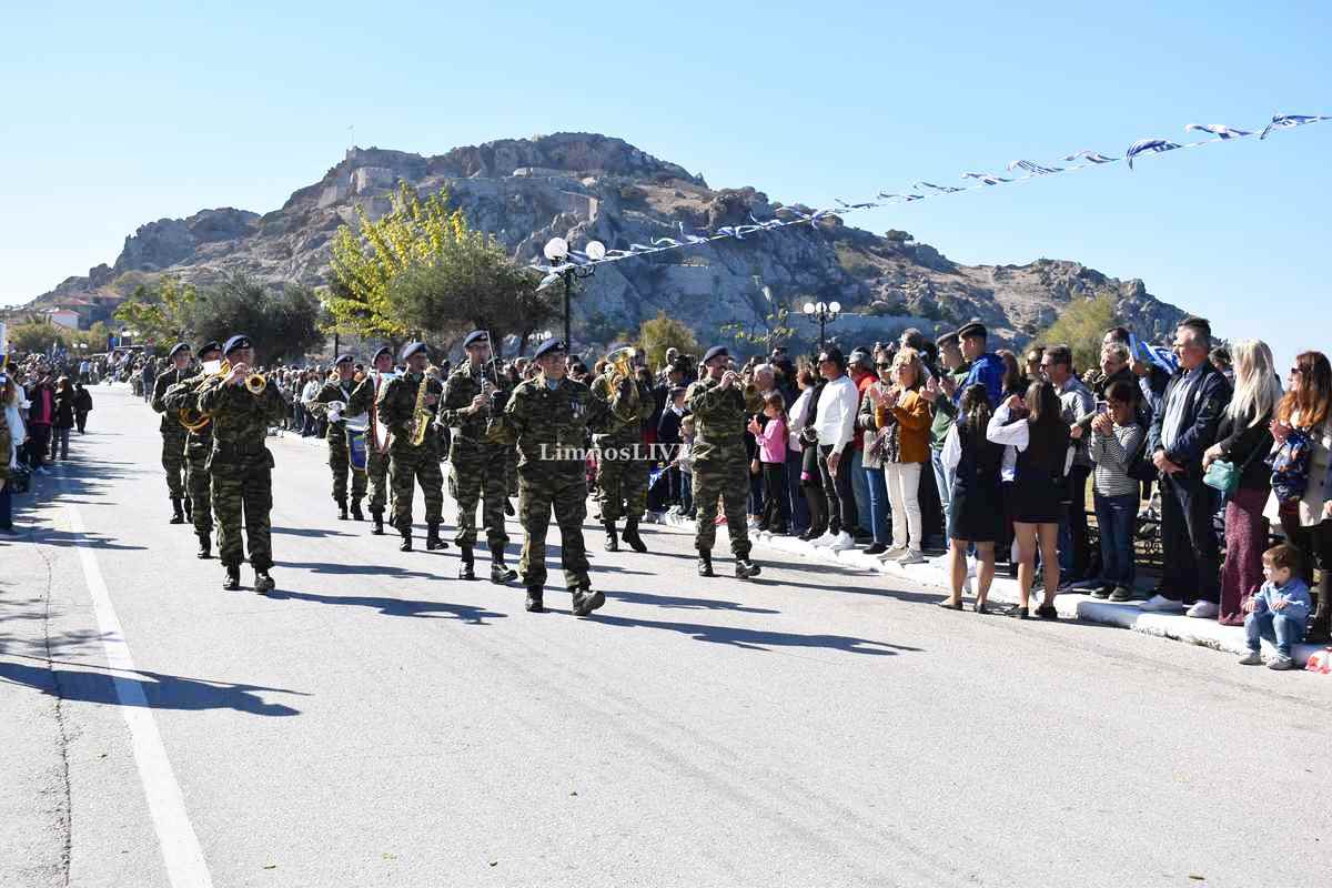 a man playing a drum in front of a crowd of people