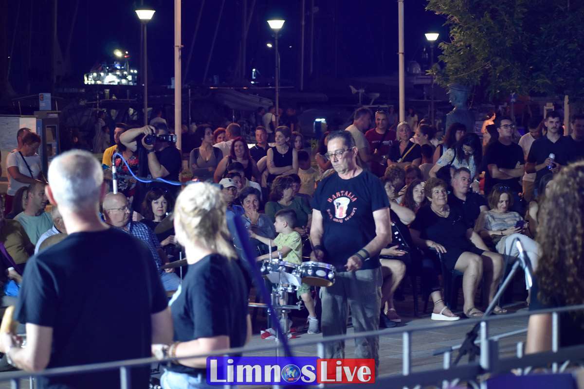 a man playing a drum in front of a crowd of people