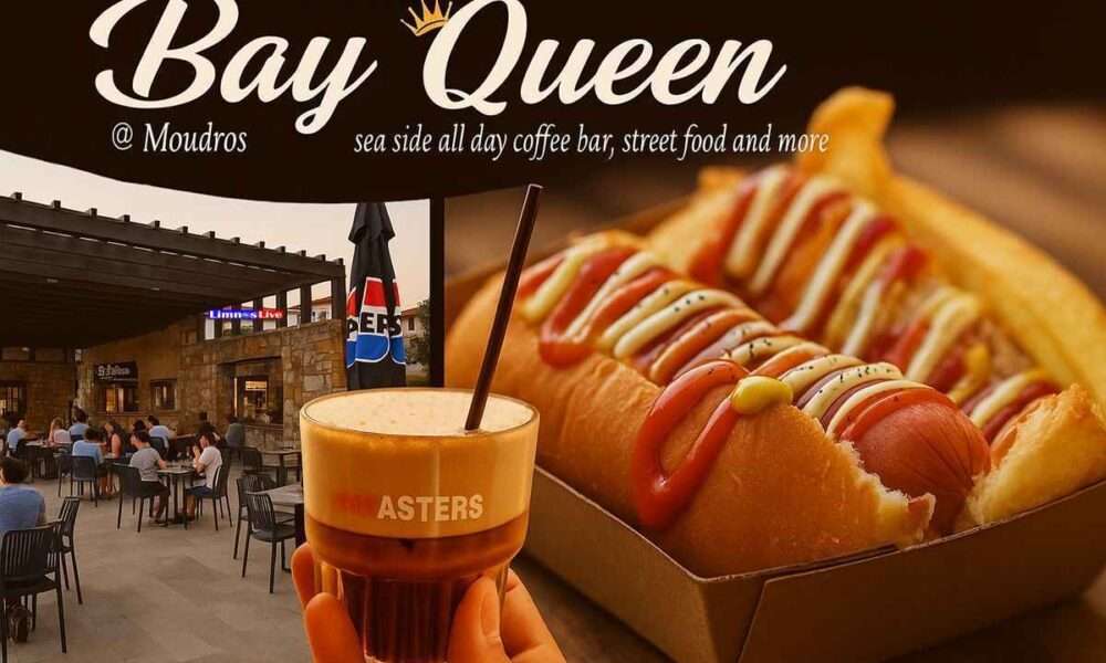a hand holding a drink and a hot dog in a restaurant